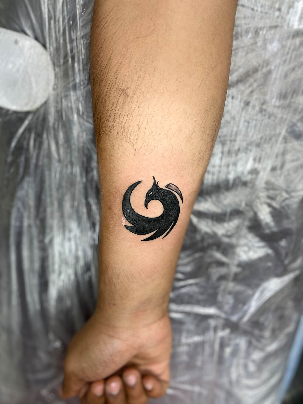 Phoenix tattoo on hand tribal small circle