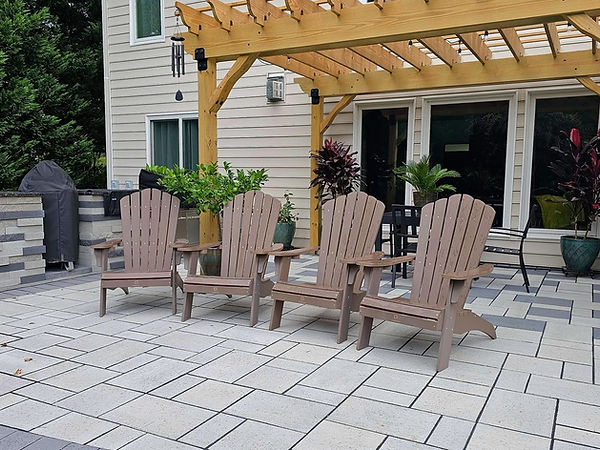 Patio with a wooden pergola and some beach chairs