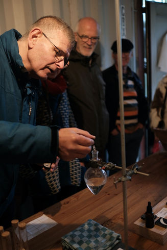 man working in the lab, putting the exlixer in the bottle