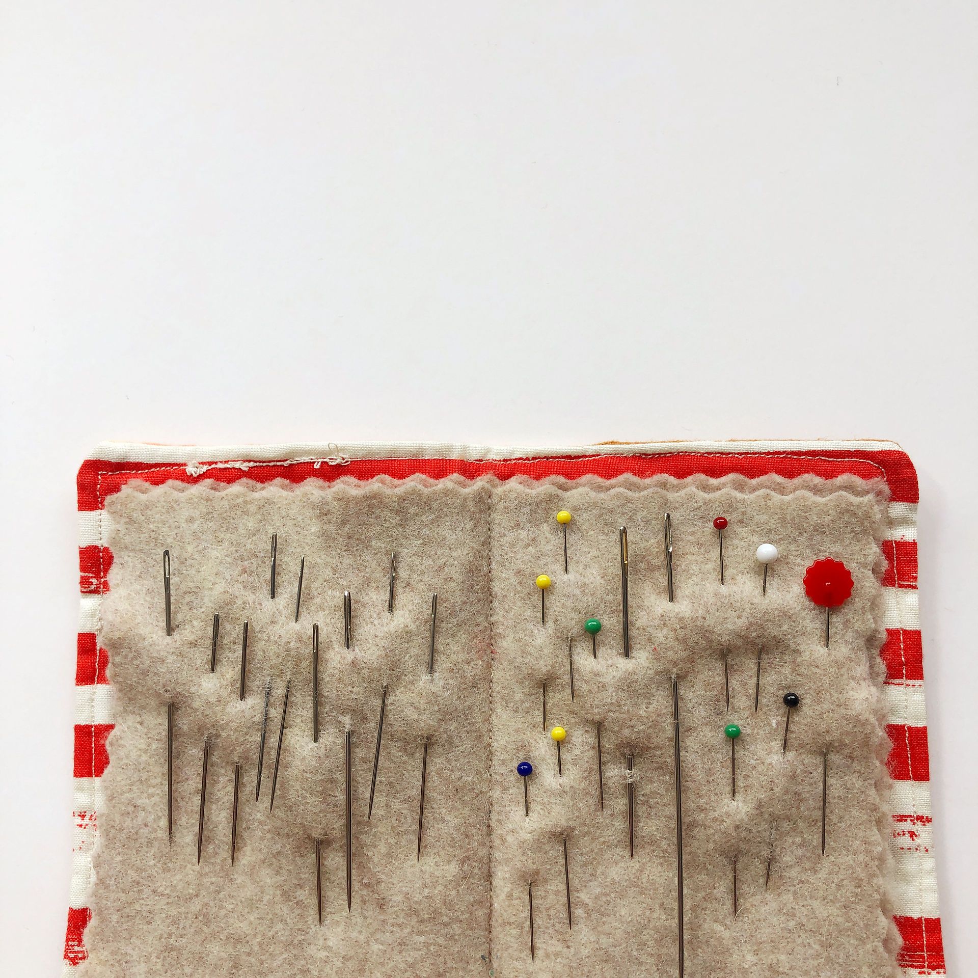 inside of a needle book- felt book pages holding pins and needle