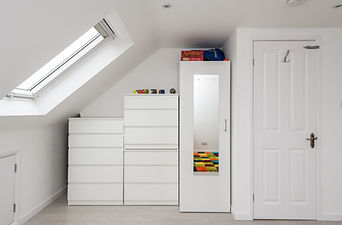 Cleverly arranged cabinets beneath sloping roof