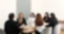 Consultings team members engaged in a lively discussion around the table.
