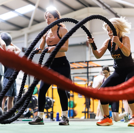 Large group training session doing ropes exercise