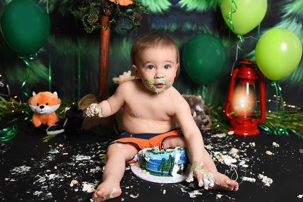 jack's celebrating one session. outdoors cake smash