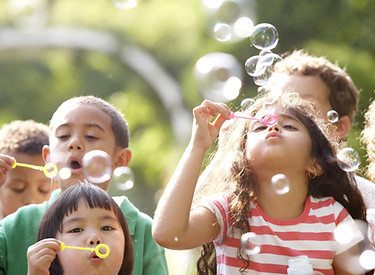 Kids Blowing Bubbles during outside time in child care
