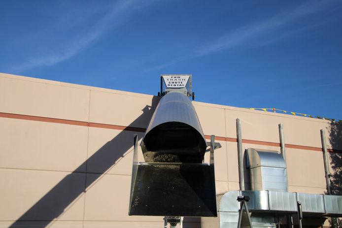 PNW Trash Chute Rentals 50ft chute in action—streamlining rooftop debris cleanup a commercial building Portland OR