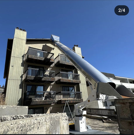 PNW Trash Chute Rentals 50ft chute in action—streamlining rooftop debris cleanup a commercial building Portland OR