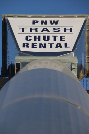 PNW Trash Chute Rentals 50ft chute in action—streamlining rooftop debris cleanup a commercial building Portland OR