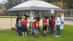 At this station Elisa Garnsey and Sydney McGovern are teaching the children about sheep.