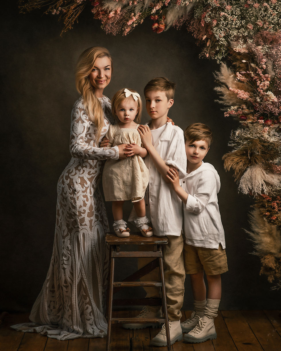 A heartwarming family portrait featuring a mother with her three children, standing together in front of a beautifully arrang