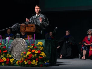 Ford Clark stands at a podium delivering a speech to students and faculty at Ohio University’s President’s Convocation during his senior year.