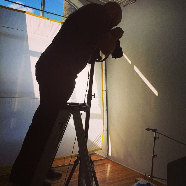 photographer on a ladder taking picture