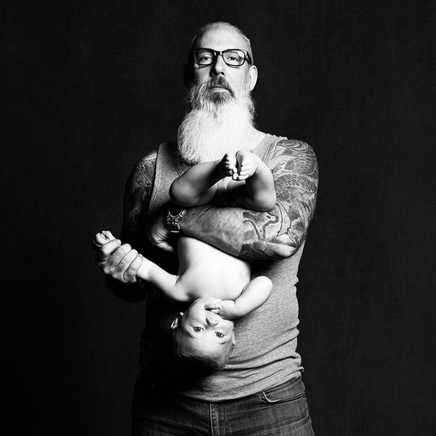 Portait noir et blanc de père et son bébé en pose surprenante