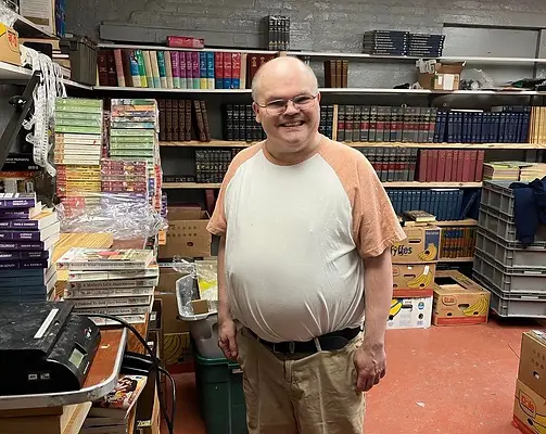 A VTDC client smiles as he works for a local business client