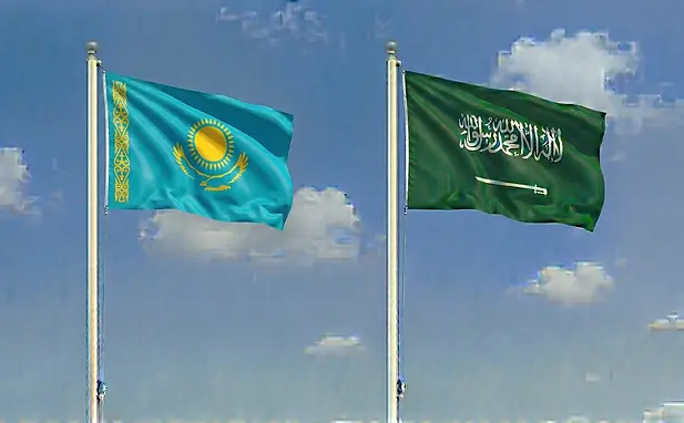 Kazakhstan and Saudi Arabia travel imagery featuring both flags under a sunny blue sky.