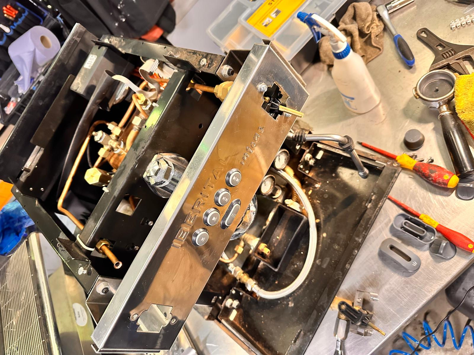 barista at coffee machine steaming milk