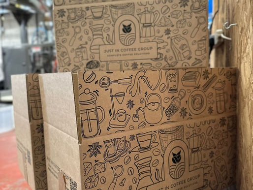 a stack of new branded Just In Coffee Group delivery boxes