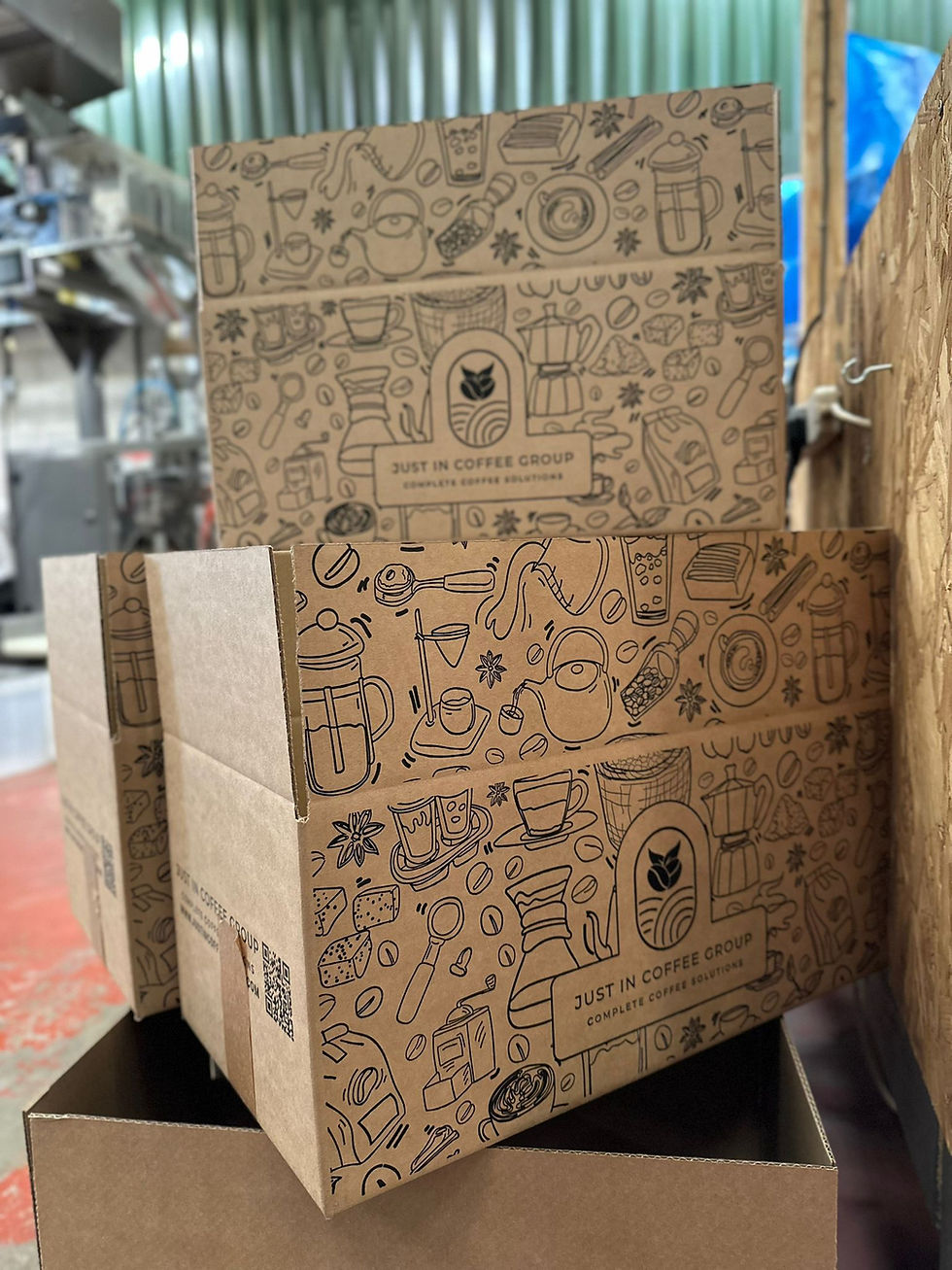 a stack of new branded Just In Coffee Group delivery boxes