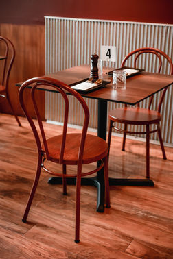 Warm minimalist interior with brown tones, maroon accents, and contemporary African artwork.