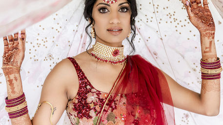Bride from Biltmore wedding in Asheville showing her bridal mehendi in red outfit