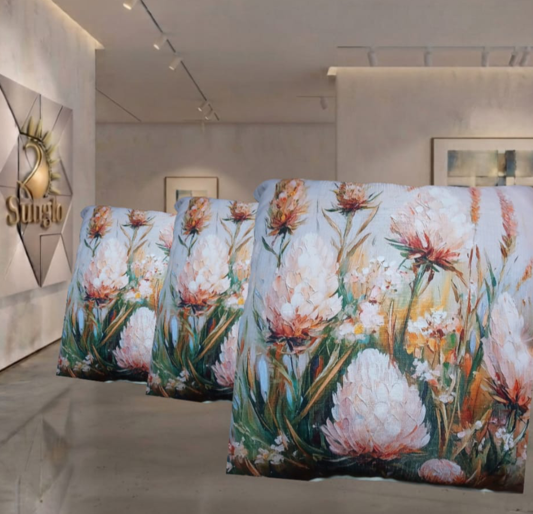 Three apricot scatter cushions with floral patterns in a shop