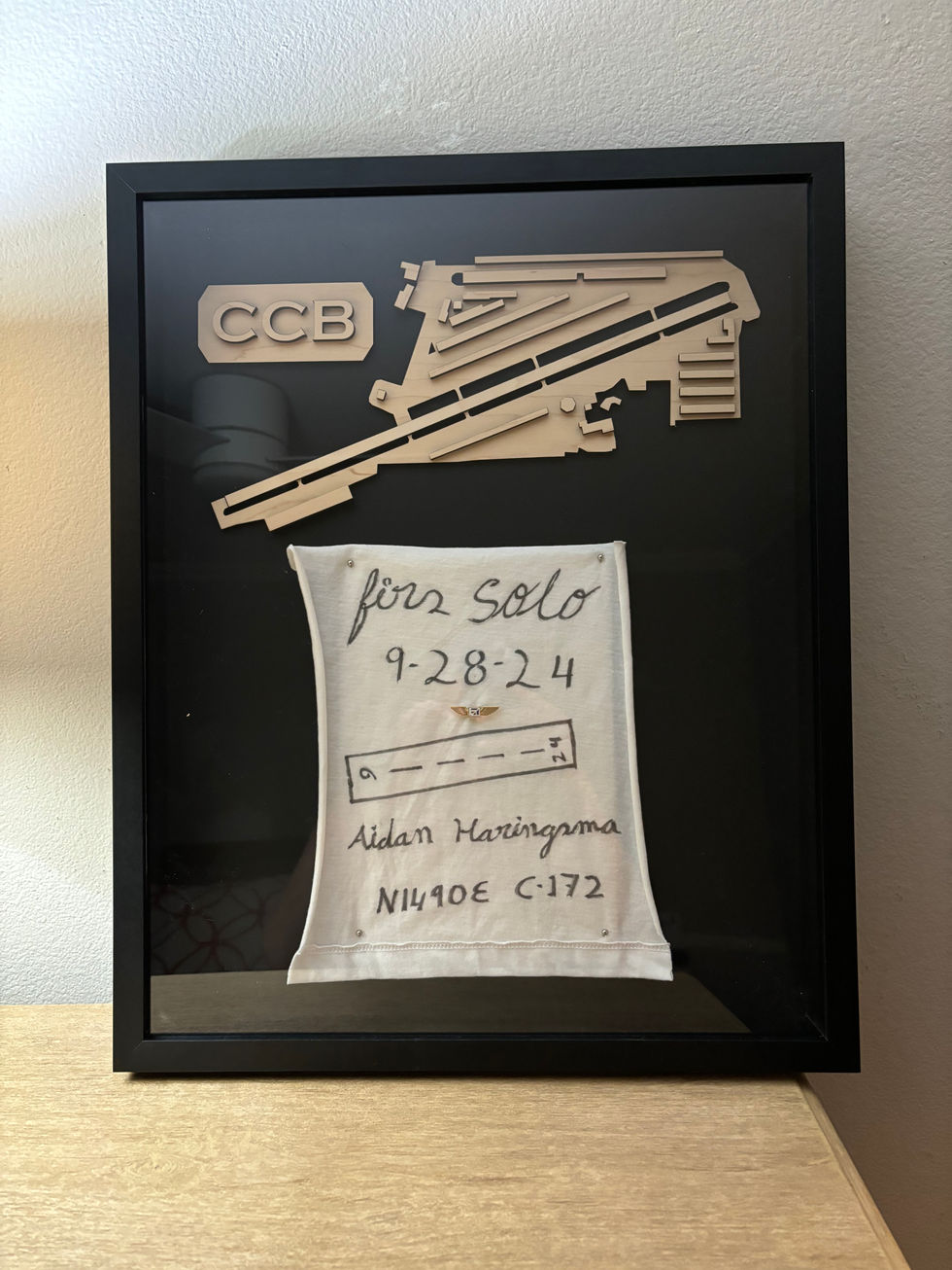 Shadow box with airport and First Solo T-shirt