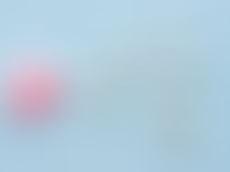 Illustration of sperm cells approaching a pink egg on a blue background—representing the process of conception, egg donation, and sperm donation in fertility treatments
