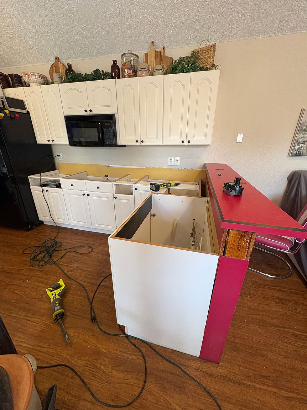 Pool house kitchen during renovation with the old countertops removed and the red raised bar still in place