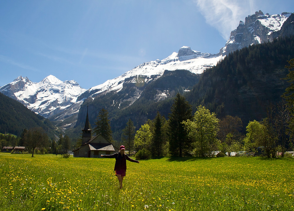Woman standing in a swiss meadow