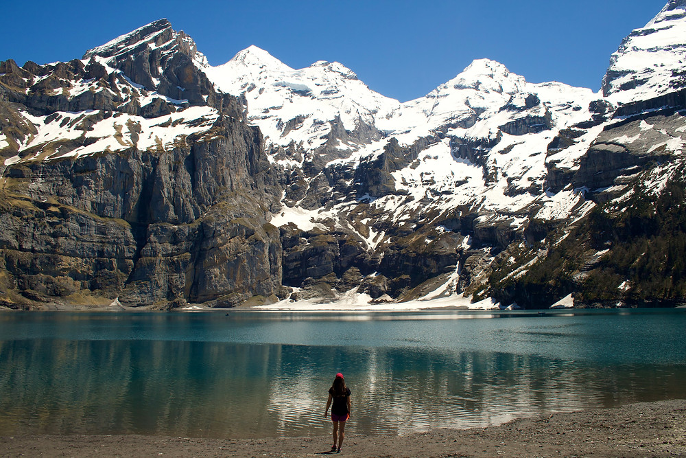 Woman standing in front of Oeschinensee, alpine lake