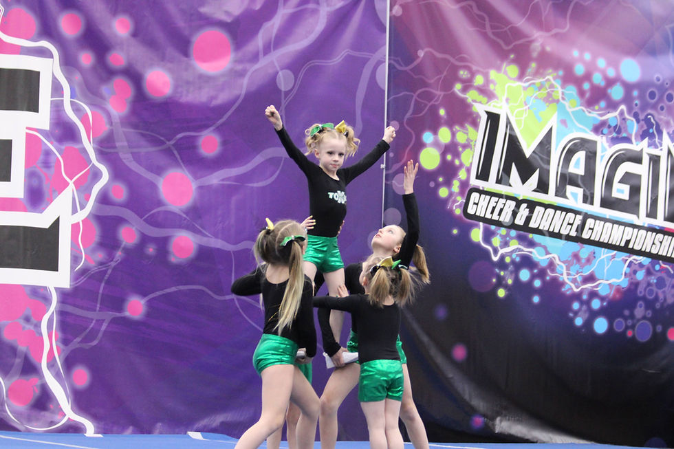 Three young cheerleaders doing a pose