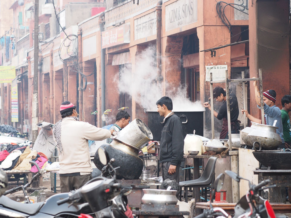 a street scene with a sign that says azma sons