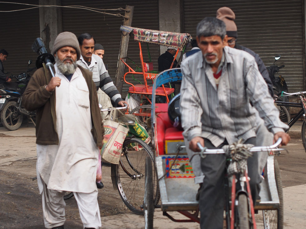 a man riding a bicycle with a bag that says ' aa ' on it
