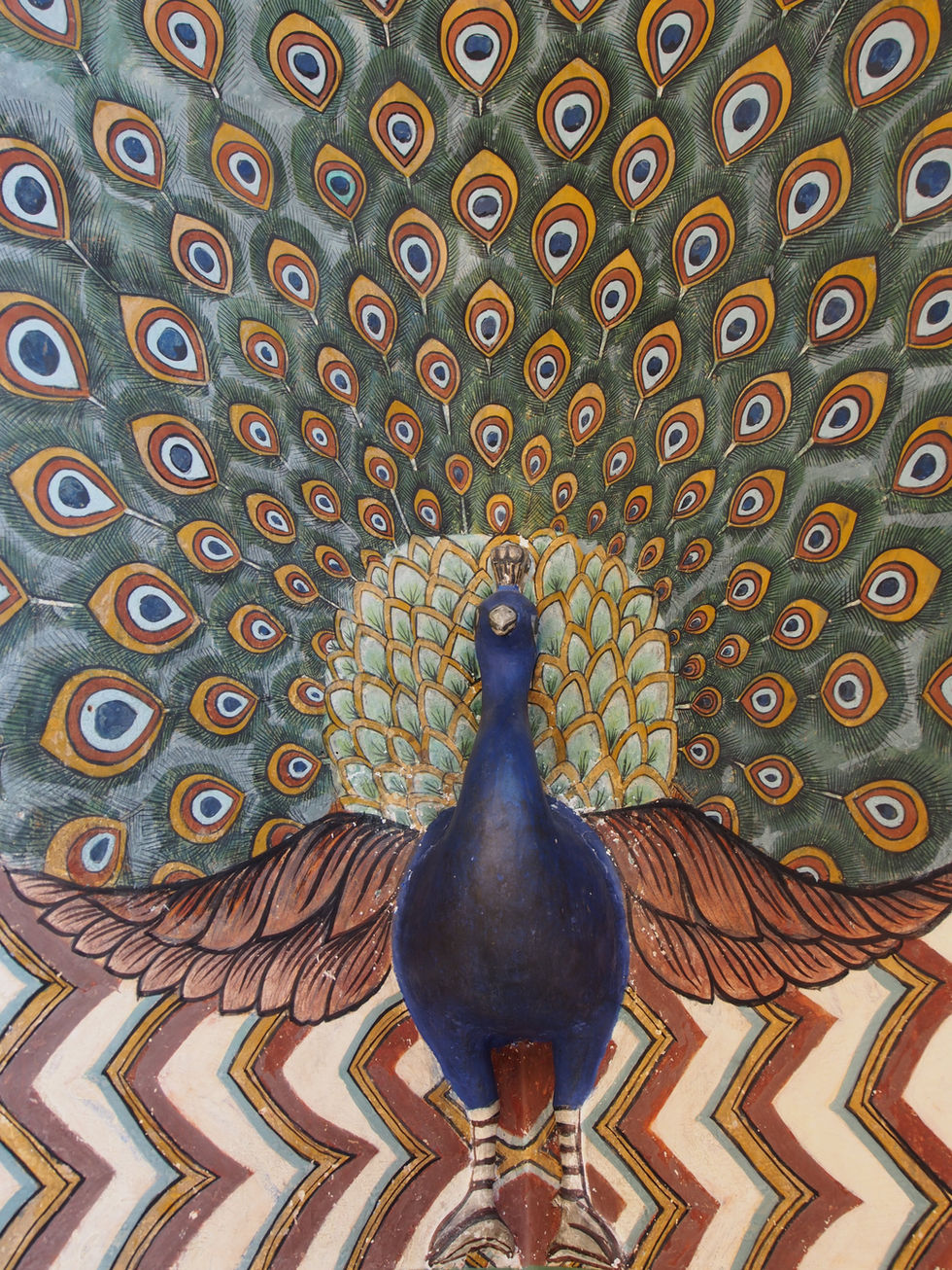a statue of a peacock with its feathers spread out