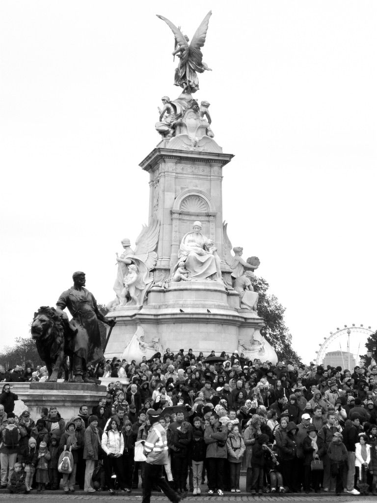 a crowd of people are gathered around a large statue