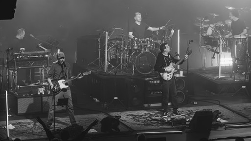 A concert photo of Umphrey's McGee full band in black and white performing live in Morristown, NJ. The photo is taken by Ryan Downey Jr. for S!CK Entertainment