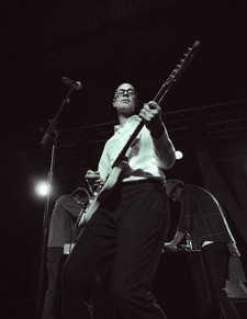 A black and white photo of singer Forrest Kline of Hellogoodbye performing live at Starland Ballroom in Sayreville, NJ. The photo is taken by concert photographer Ryan Downey Jr for S!CK Entertainment