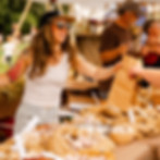 Woman exchanging local farm goods at communal event.