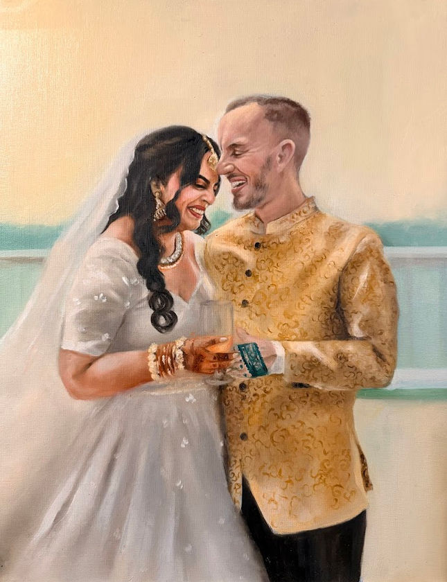 Live wedding painting of a couple embracing, the bride in a white gown and the groom in a gold sherwani