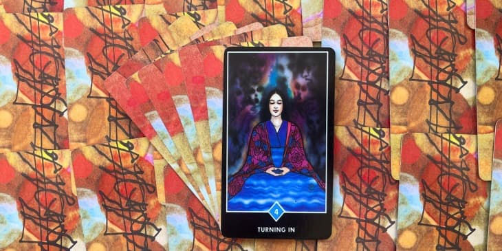 Carta do Tarot Zen osho tem uma mulher meditando em paz em quanto tem uns vultos de rostos atrás dela.