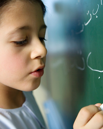 Boy Writing on a Blackboard