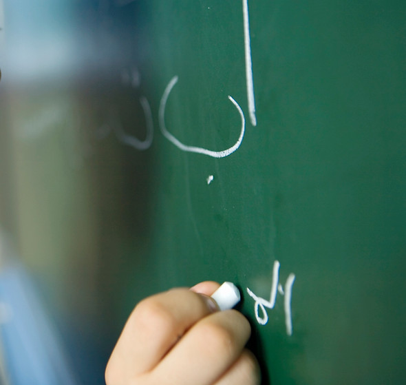 Boy Writing on a Blackboard