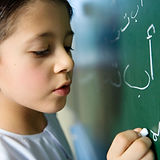Boy Writing on a Blackboard