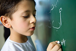 Boy Writing on a Blackboard