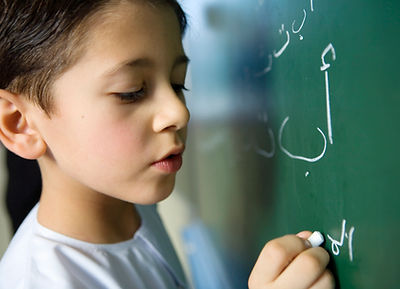 Boy Writing on a Blackboard