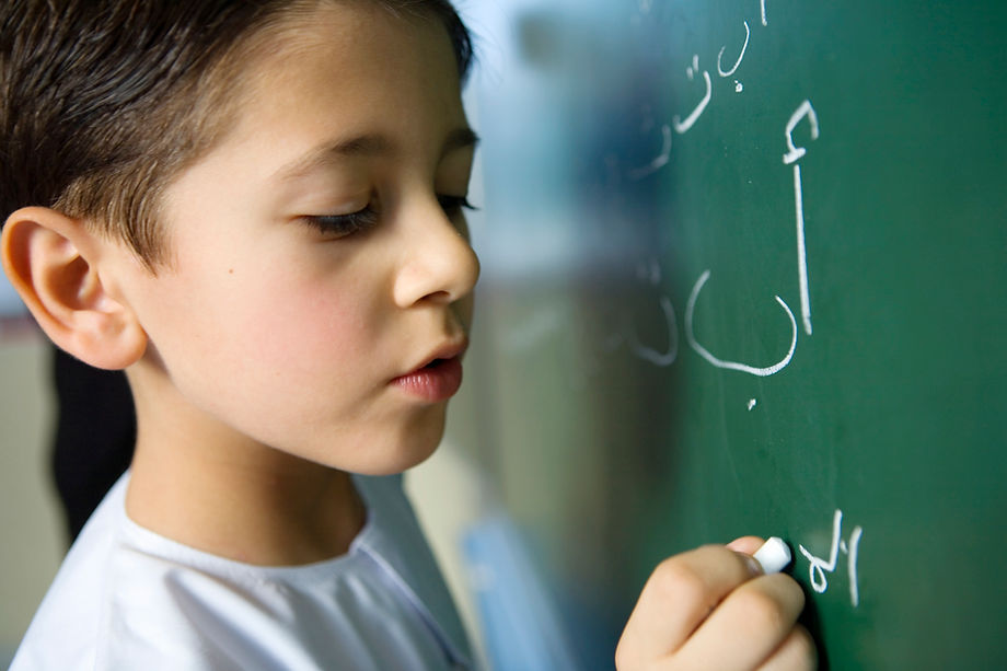 Boy Writing on a Blackboard