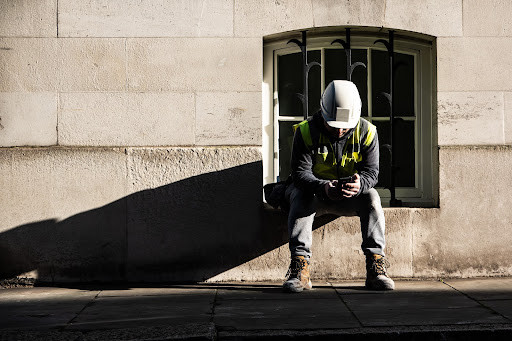 a construction worker texts HARDHAT to 85258 to access free and confidential guidance and support over text.