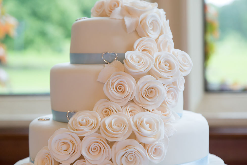 Wedding cake with cascading roses running down the side.
