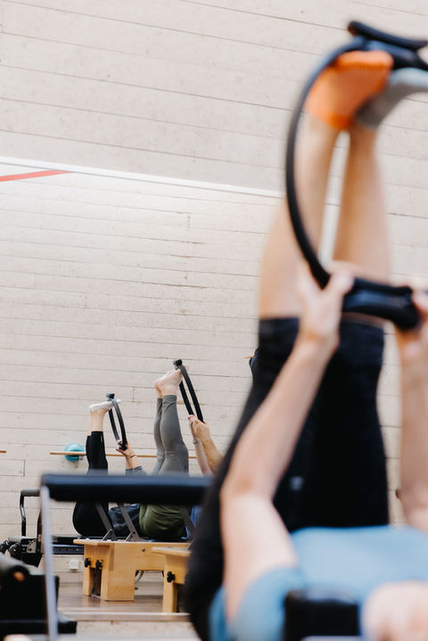People stretching on the pilates reformers at Vanessa Vette Pilates Studio in Gisborne