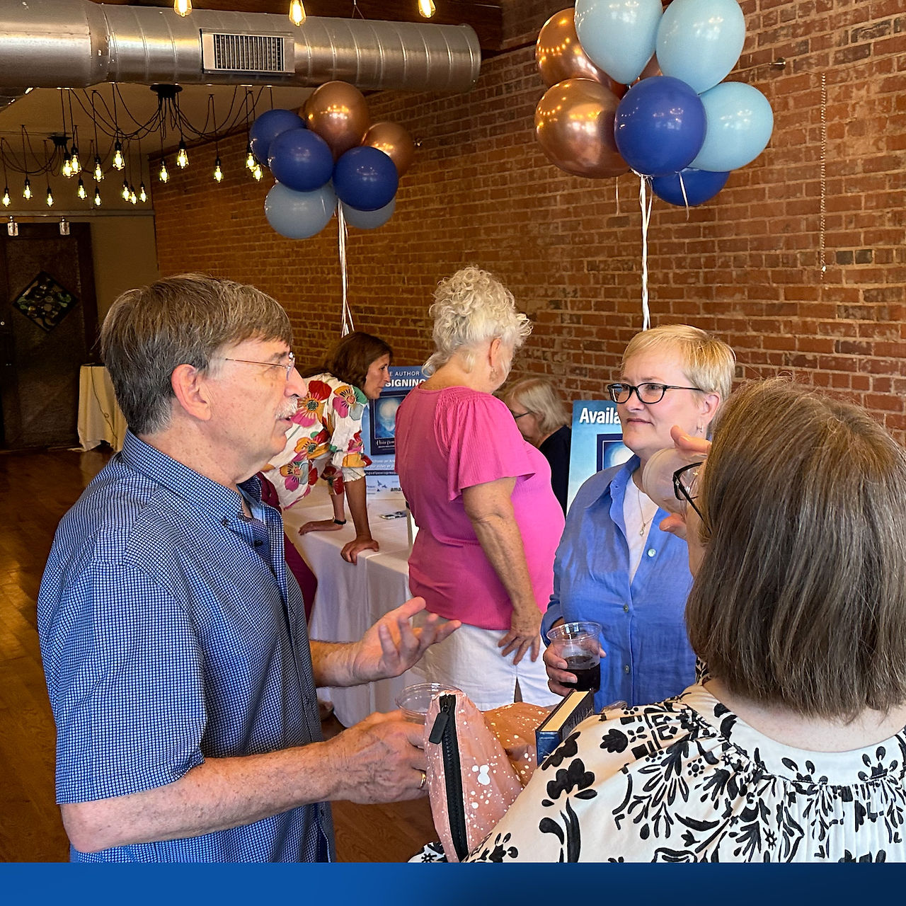 Tom Girman speaking with friends